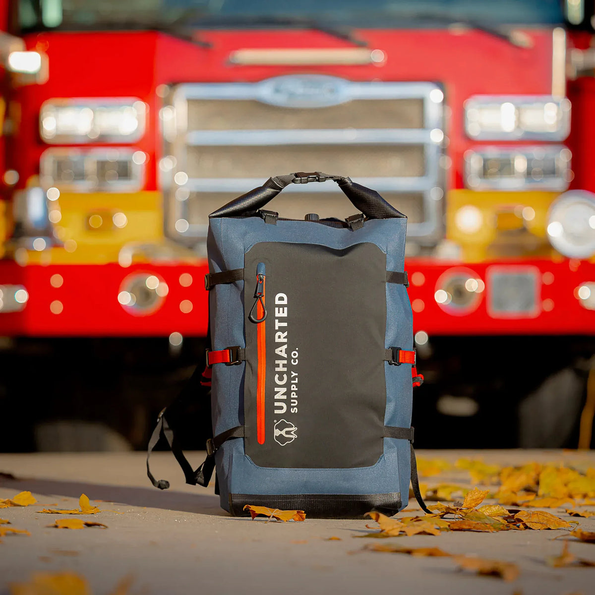 The Seventy2 Pro survival system in Deep Blue in front of a fire engine